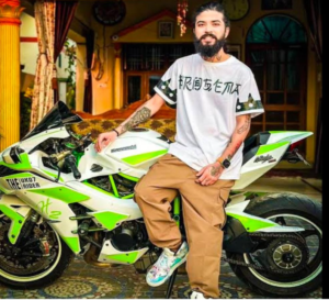 guy standing with a green and white colour bike 